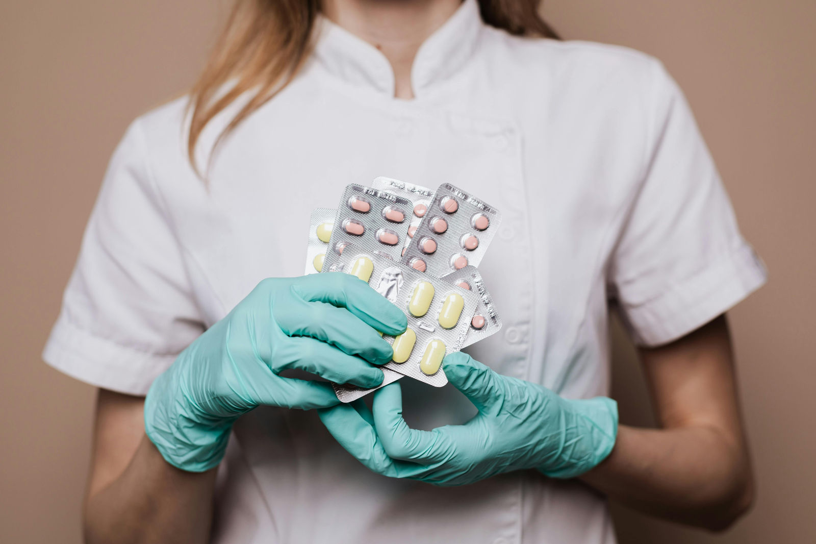 doctor holding up several different pill packs with different pills in each